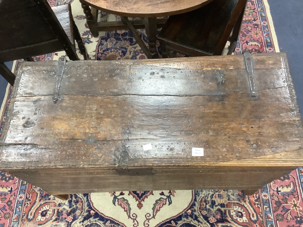 An early English oak six plank coffer, with shallow incised roundels and arched borders, 17th century, width 114cm, depth 50cm, height 72cm